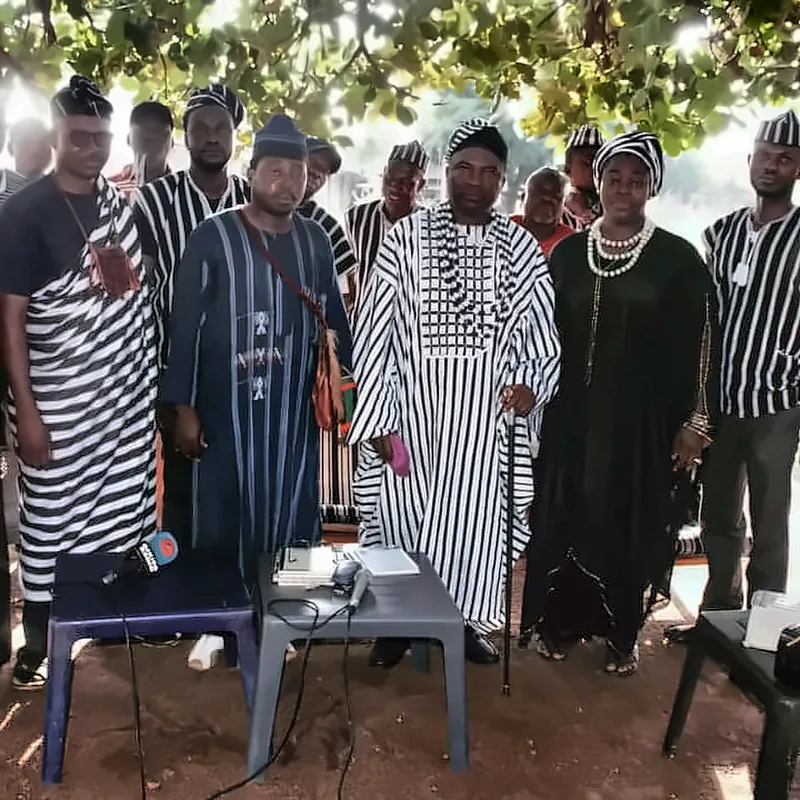 Members stand behind a table during the assembly