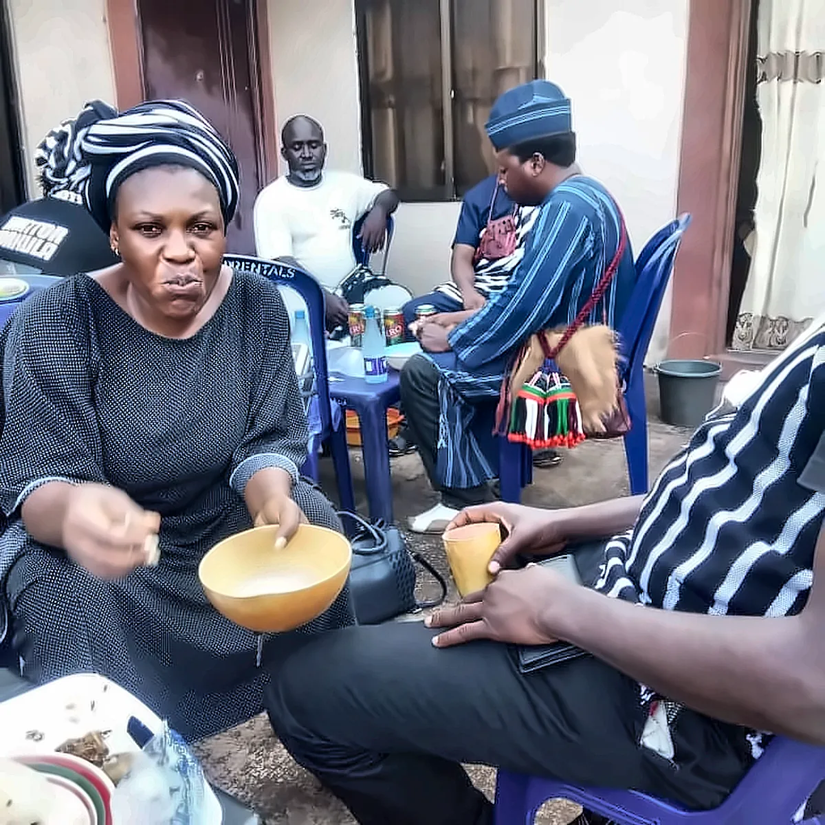 A member of Gba’Aôndo U Tiv shares a traditional meal from a calabash bowl